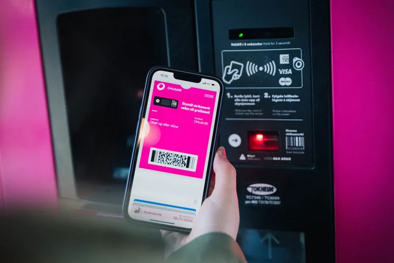 The Orkan discount card in a phone wallet, held up to a pump